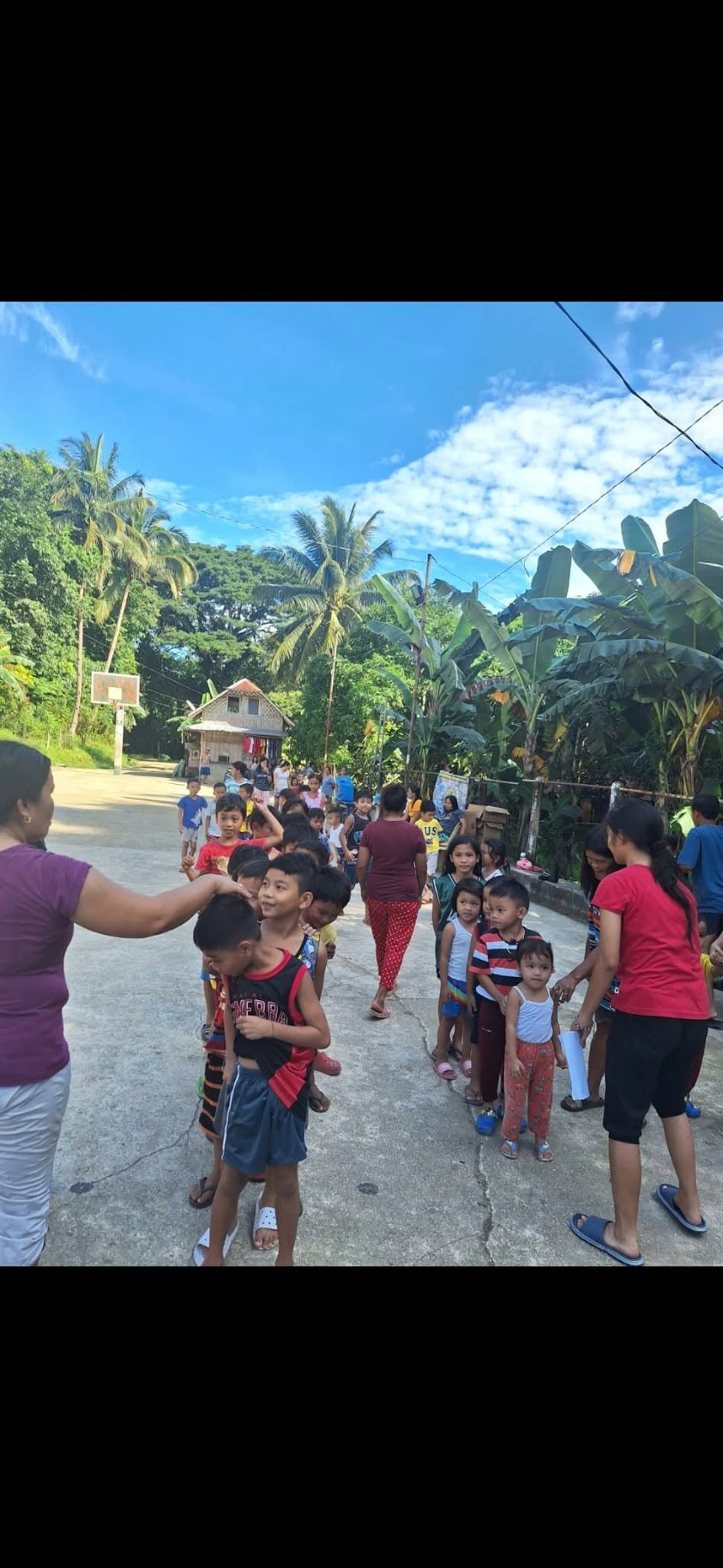 Children and adults gathered outdoors