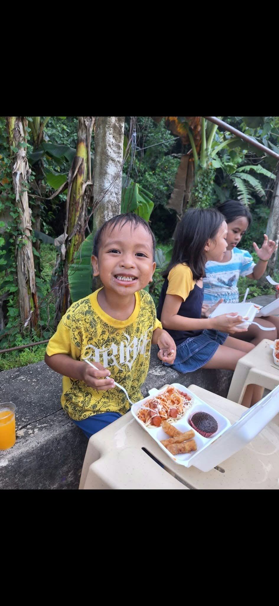 A child receiving food during a feeding activity