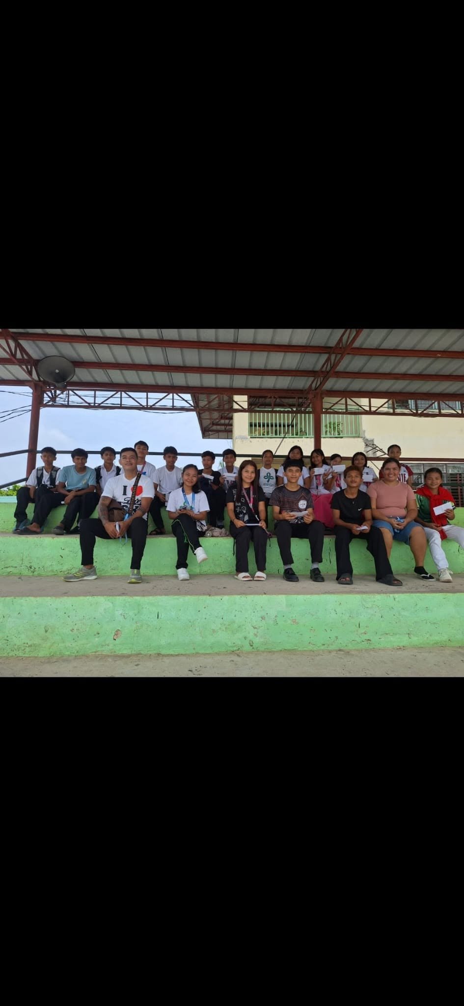 Group of students gathered at a covered school venue